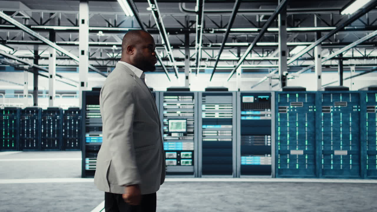Vertical video System administrator walking in data center with rigs doing backups