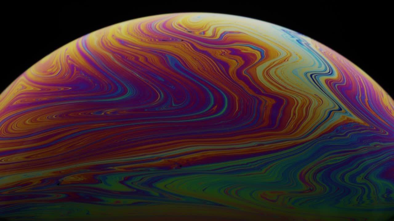 Macro Abstract Shot of Colorful Swirls on Liquid Soap's Film Surface