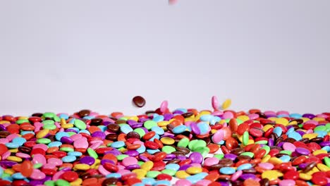 vibrant candies cascade onto a growing pile