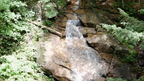 Clear-water-streams-down-stones-into-a-small-waterfall