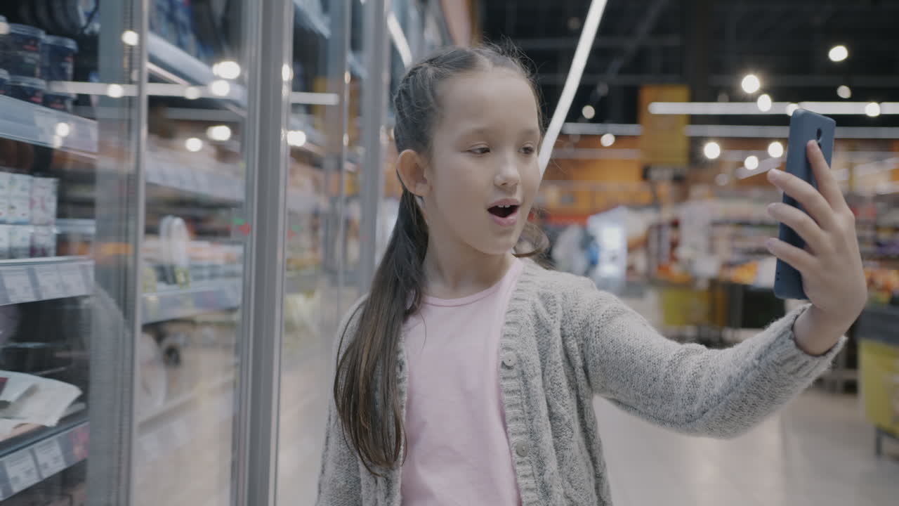 Girl taking a selfie in a grocery store