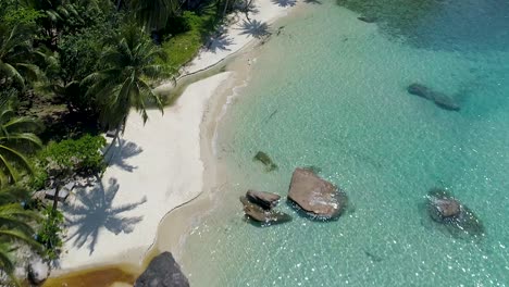 aerial, drone shot over a paradise beach, at the turquoise sea, on a sunny day, in koh kood, thailand, asia