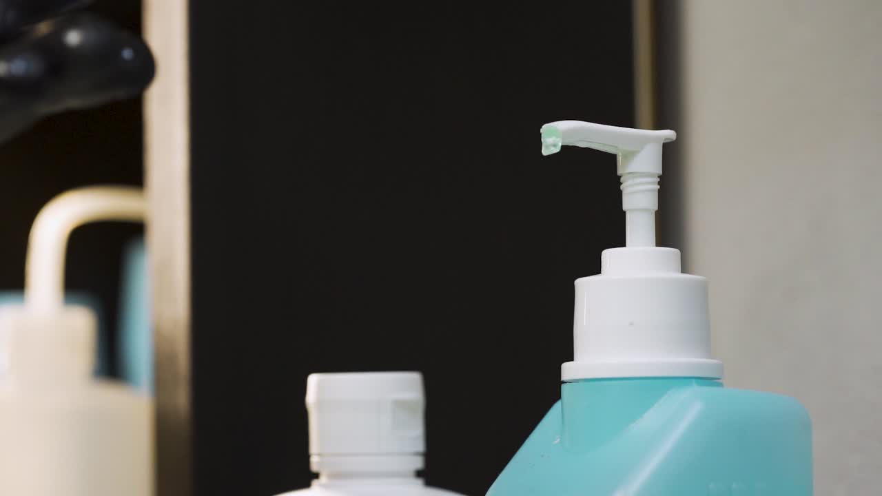Hands with black gloves put sanitizer gel in hands, shot in 120fps slowmotion