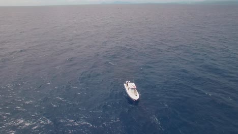 static aerial view on boat achored in open tropical sea water