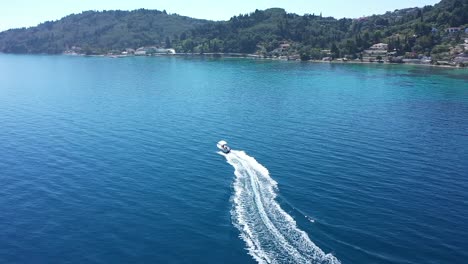 panoramic view of a motor boat riding along the greek coast on a sunny day