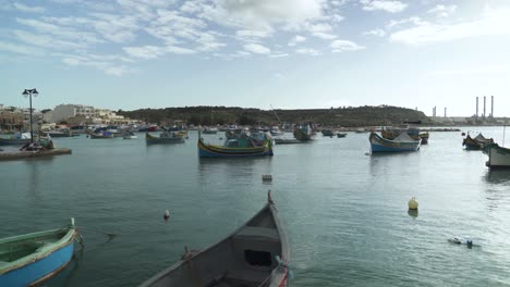 marsaxlokk bay with traditional fishing boats decorated with osiris eyes in the harbour