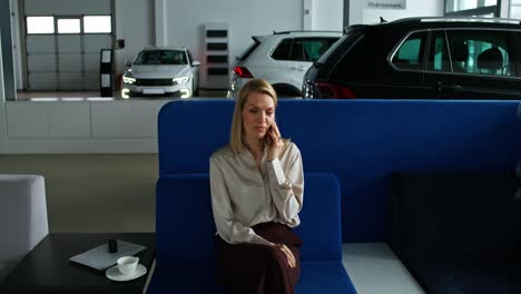 woman waiting at car dealership