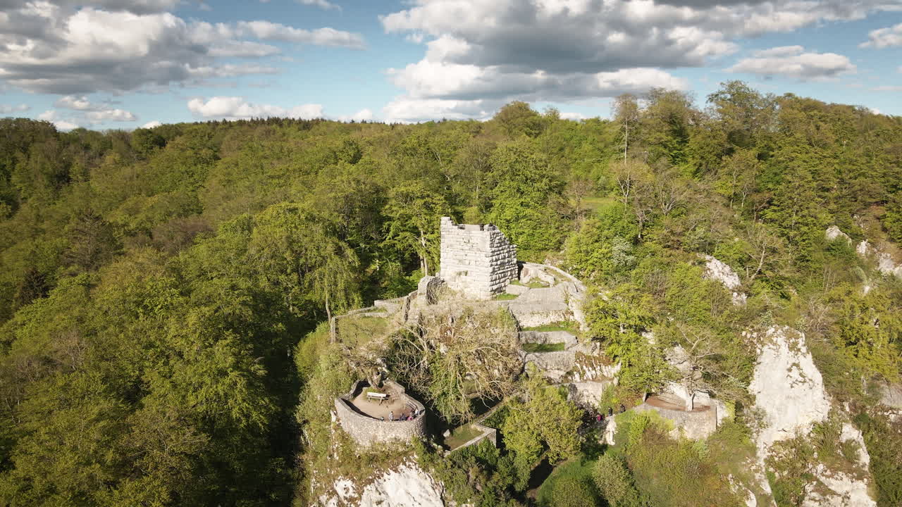 Dinamica orbita di drone 4K UHD attorno al mastio e alle mura in pietra del castello di Hohengundelfingen, che rivela scogliere calcaree boscose e il paesaggio del Giura Svevo.