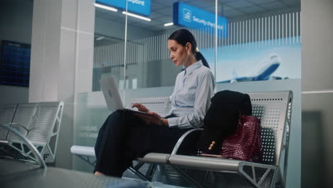 businesswoman working on laptop in airport