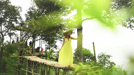 a young woman walking on a footbridge on top