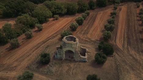 Abbazia-di-San-Bruzio,-an-old-damaged-ruin-of-an-abandoned-medieval-monastery-abbey-church-in-Tuscany-from-the-11th-century-surrounded-by-olive-trees-in-Italy