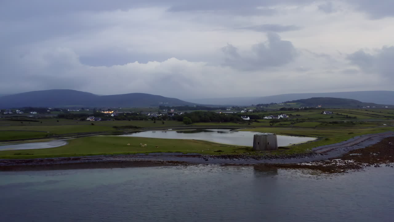 Establishing aerial of County Clare’s scenic coastline with a Martello tower featured in the foreground