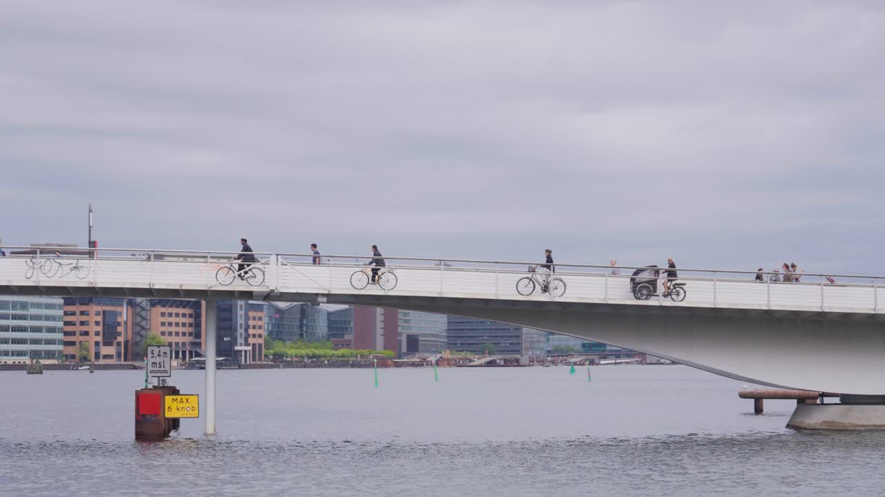 Cyclists cross main canal of inner harbor on Lille Langebro bridge, Copenhagen