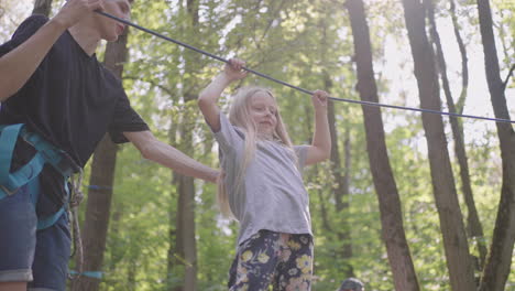 girls learn to walk on cable cars and overcome cliffs and rope crossings in a summer camp