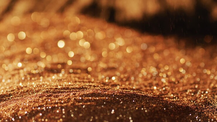 Gemme glitterate dorate che si spargono su sfondo nero