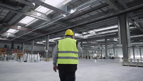 man walking inside large production hall