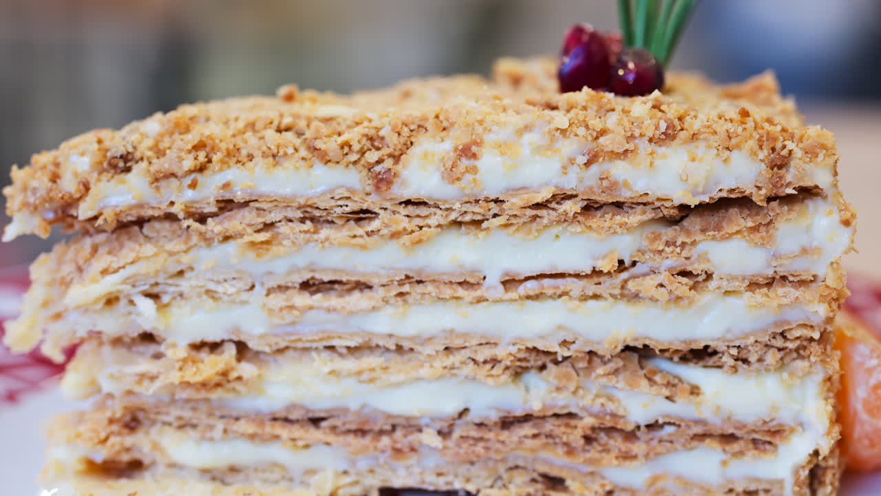 Close up of a slice of Medovik cake on a red and white plate