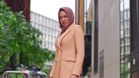 Portrait-Of-Modern-Muslim-Businesswoman-Wearing-Hijab-With-Business-Suit-Going-To-Work-Standing-Outside-Office-Buildings-1