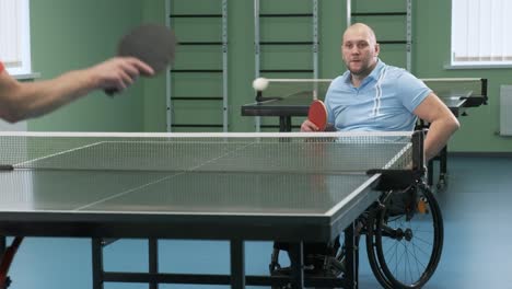 man in wheelchair playing table tennis