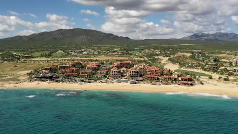 aerial, hyper lapse, drone shot, over the ocean, towards hotels and resorts, at the sheraton beach in cabo san lucas, mexico