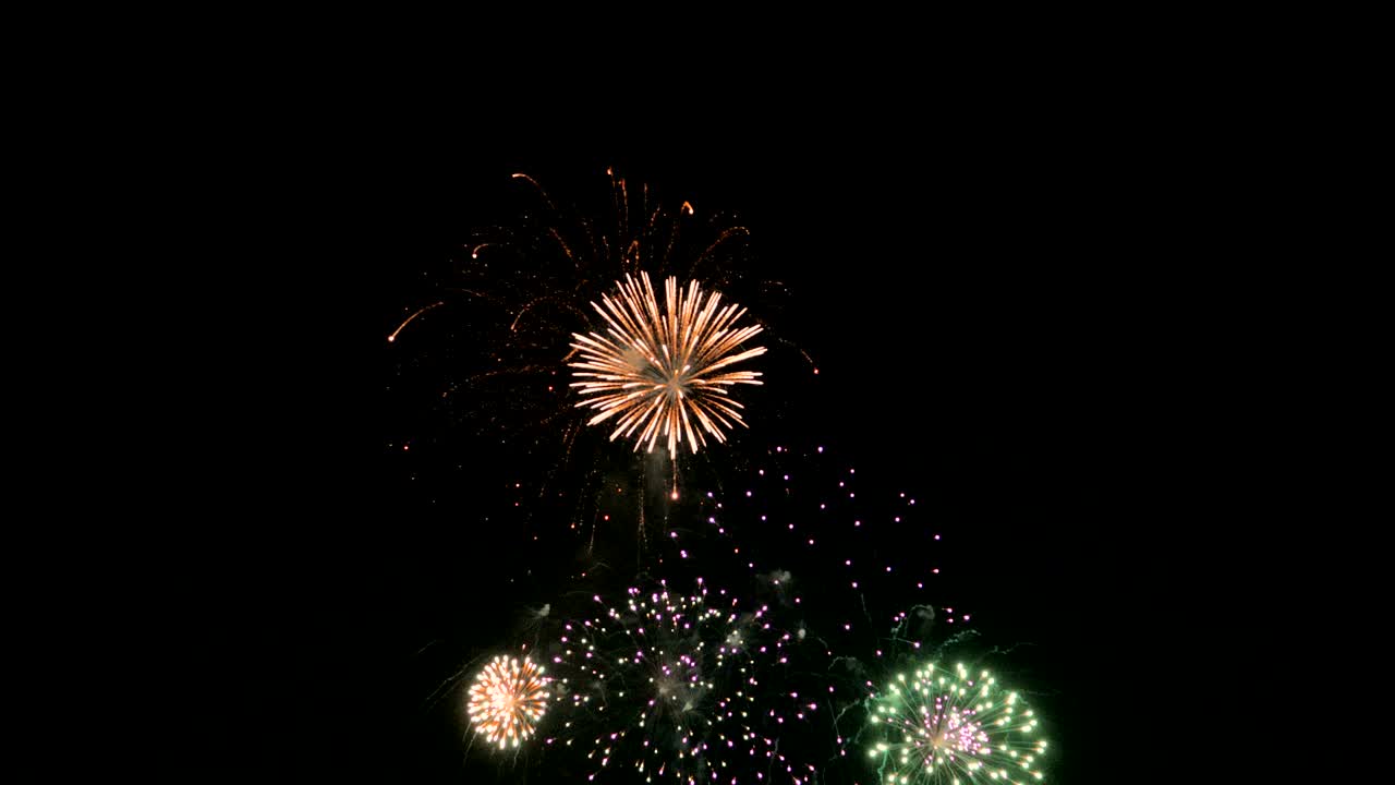 Celebration firework exploding and glow over dark background with dark and grain processed