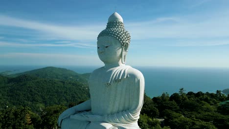 4K-Cinematic-nature-aerial-footage-of-a-drone-flying-over-the-Big-Buddha-on-top-of-the-mountains-in-Phuket,-Thailand-on-a-sunny-day