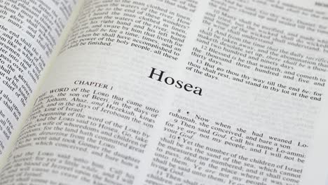 close up shot of bible page turning to the book of hosea