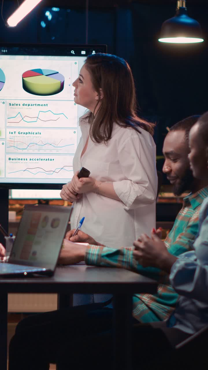 Vertical video: Company employee explaining analytics research results in business meeting