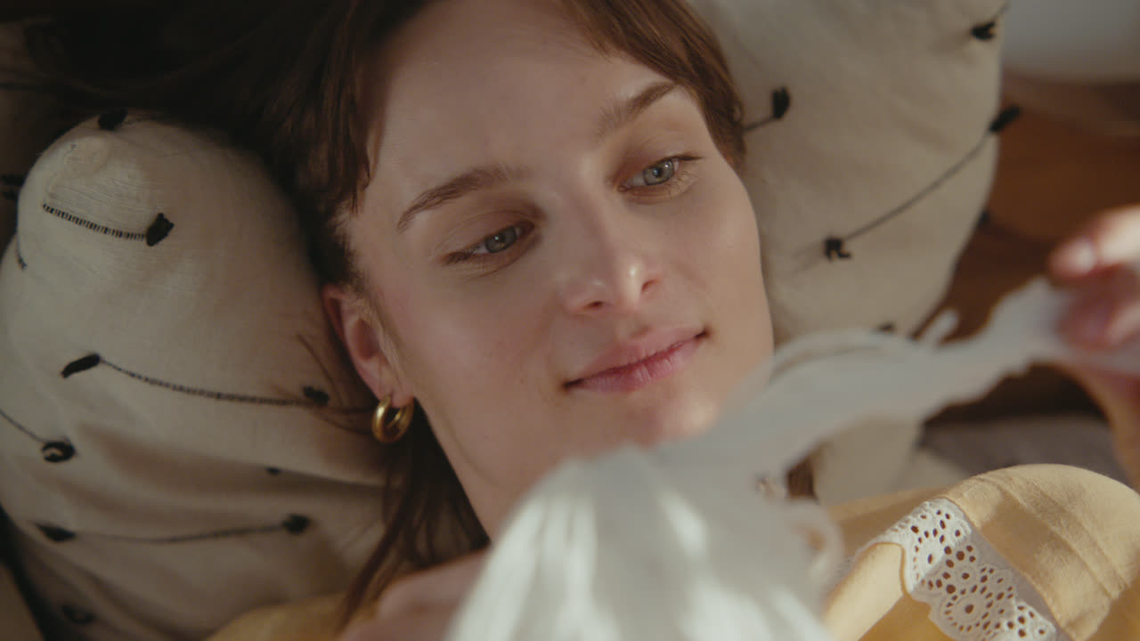 A girl playing with dolls in her room