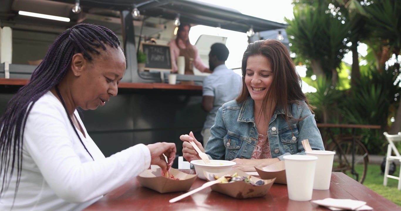 Diverse Women Friends Eating Lunch at Outdoor Food Truck
