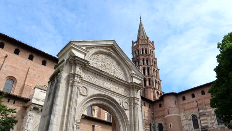 renaissance door and bell tower of basilica of saint-sernin in toulouse, france - wide shot