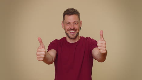 man raises thumbs up agrees or gives positive reply recommends advertisement likes good, approve