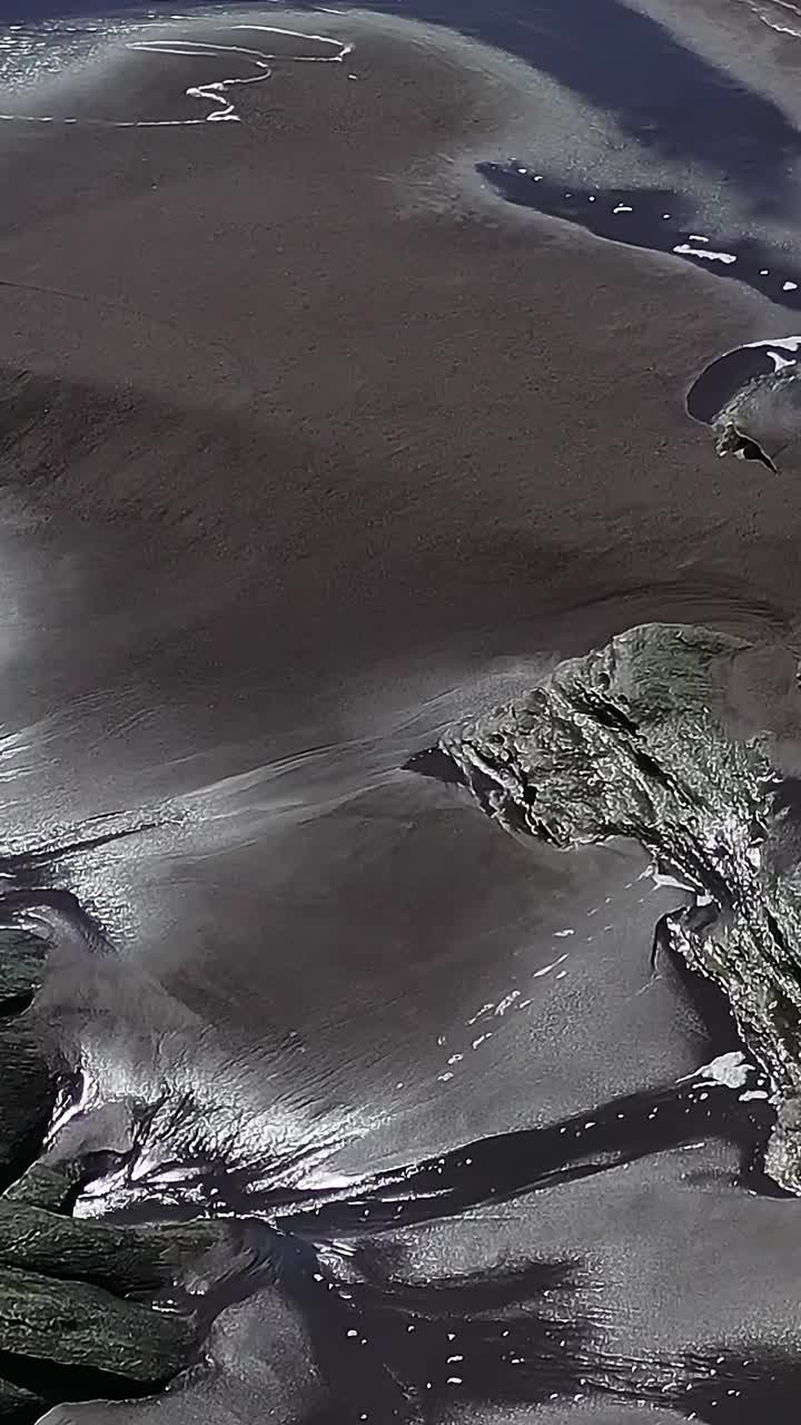 Ocean waves wash over rocks in Chile during low tide