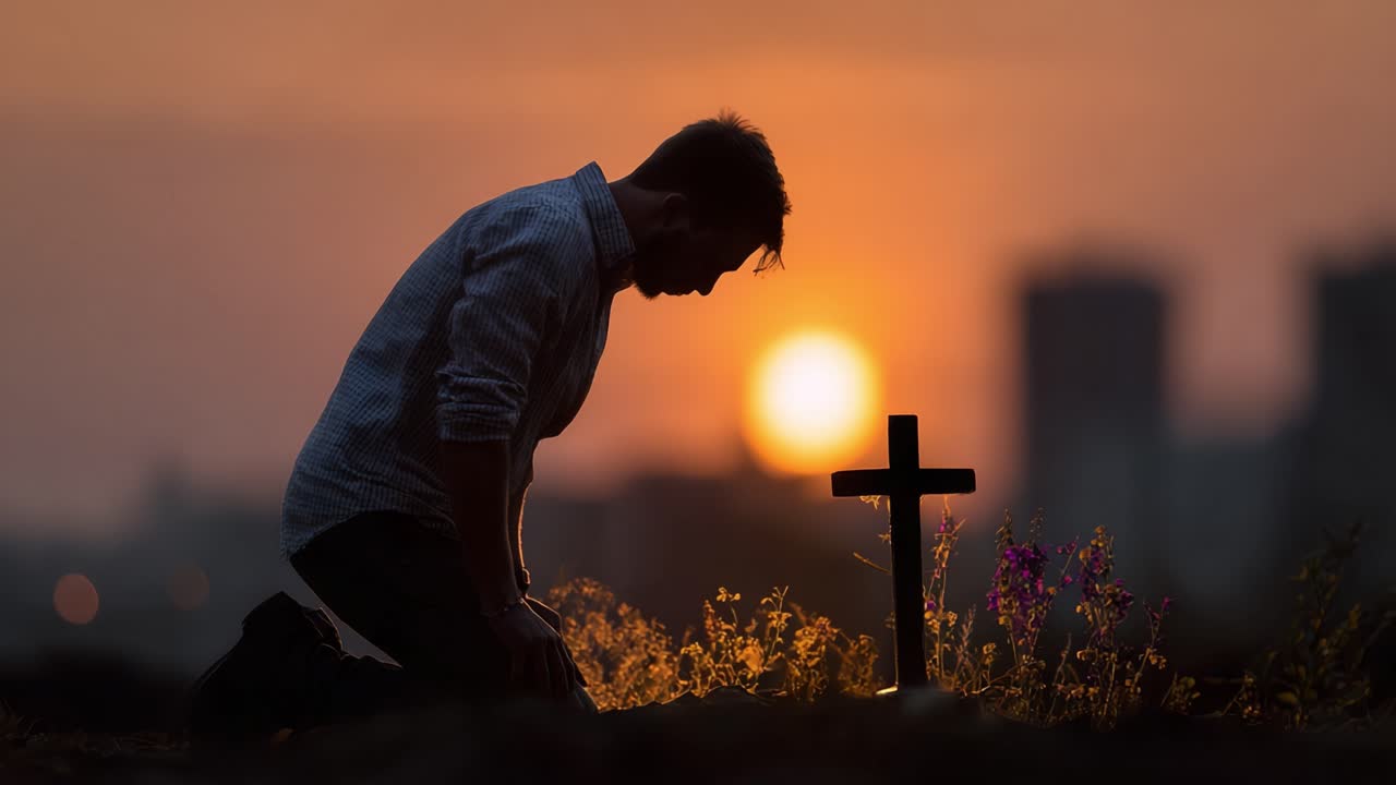 A Solemn Moment of Reflection at Sunset with a Cross and Flowers as a Man Kneels in Mourning, Signifying Loss, Grief, and Remembrance