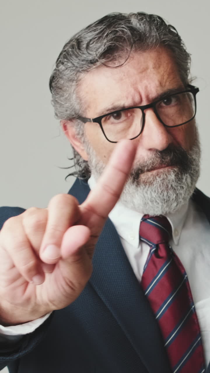 Mature Businessman Shaking Finger in Disapproval