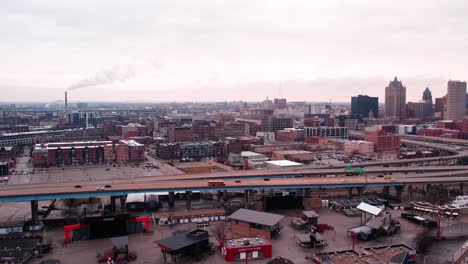 aerial-following-school-bus-on-highway-milwaukee-downtown,-wisonsin