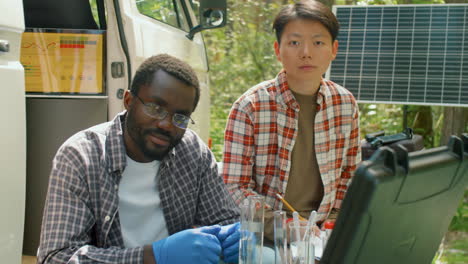 ecologists with lab glassware and samples