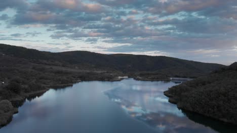 beautiful aerial over mountain lake colorful sunset clouds reflecting in water