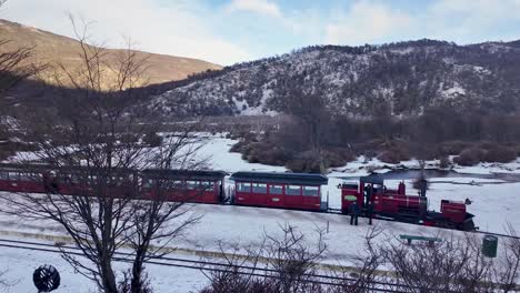 fin del mundo train at ushuaia in tierra del fuego argentina. snow capped field. railroad landscape. train station background. fin del mundo train at ushuaia in tierra del fuego argentina.
