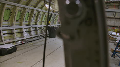 dolly-shot-of-an-airplane-under-construction