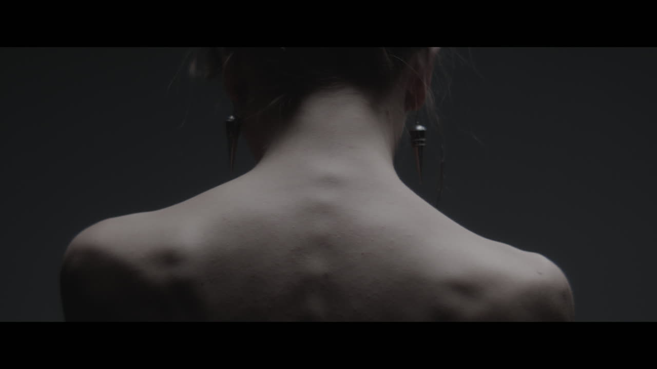 A woman dressed as mother nature moves slowly in a dance-like motion