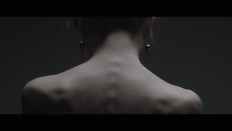 a woman dressed as mother nature moves slowly in a dance-like motion