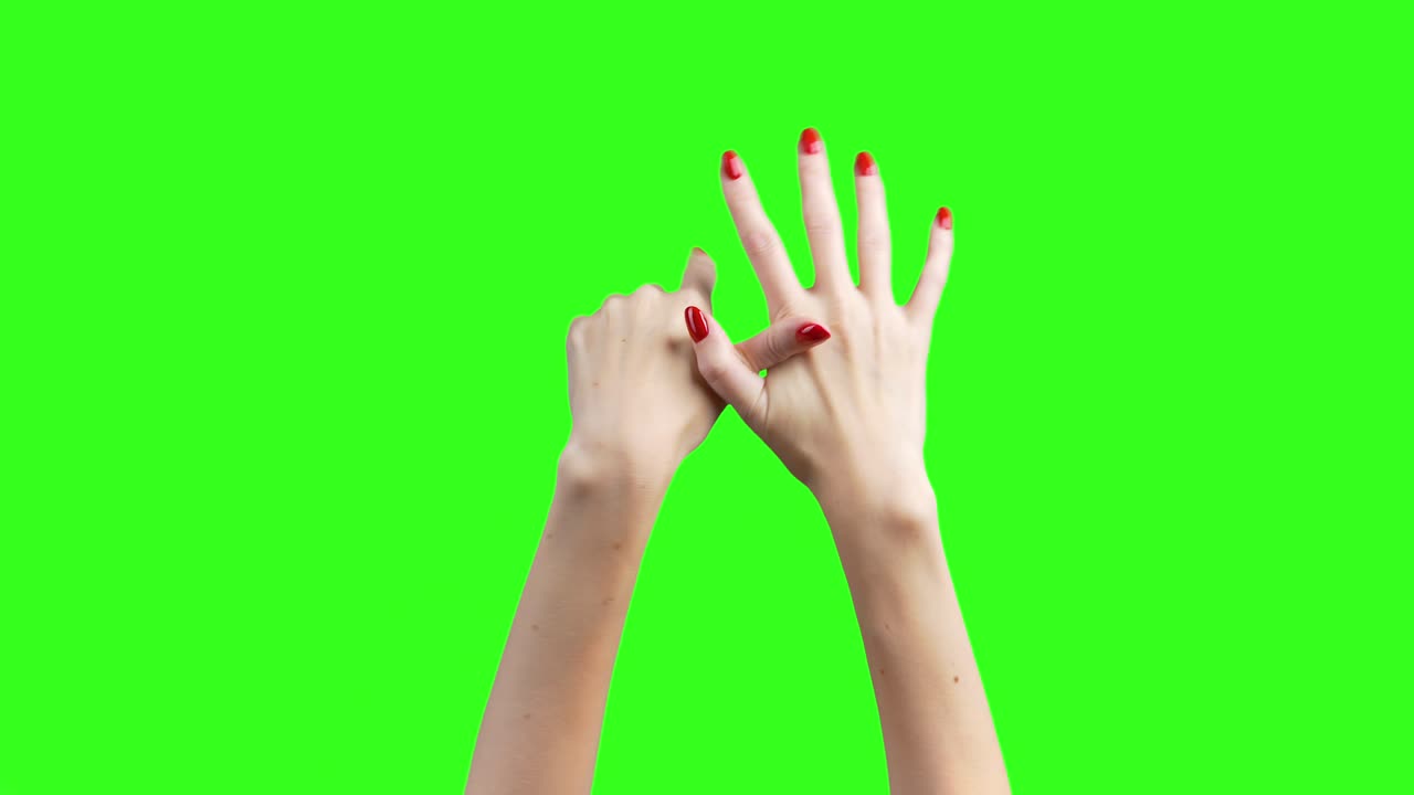Footage of female hands demonstrate fingers on green background