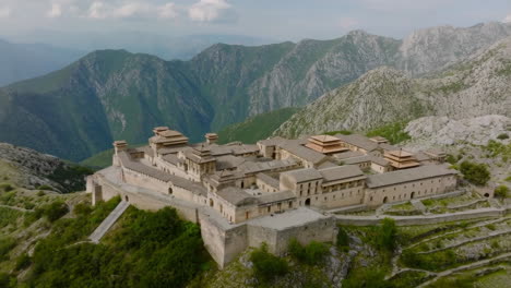 ancient fortress complex amidst mountain ranges
