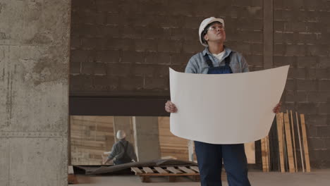 construction specialist holding large paper