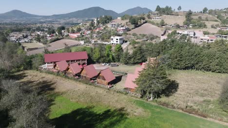 aerial view of wooden cabins in a mountain valley
