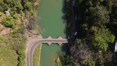 cars and trucks drive over flat bridge
