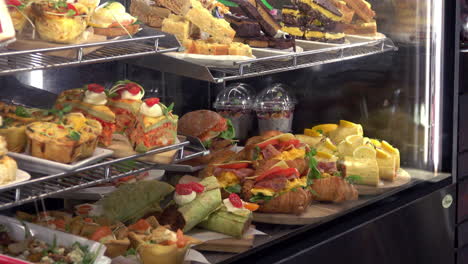 a sweeping wide shot of a food cabinet at a bakery or cafe