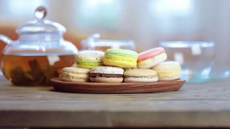 close-up of colorful macaron (macaroon) on the table with hot tea