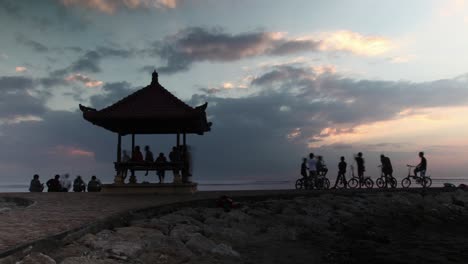 sunrise at the beach with gazebo and people